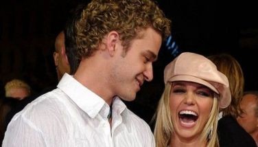 In this file photo taken on February 11, 2002 US singer/actress Britney Spears (R) arrives at the premiere of her film "Crossroads," with her then boyfriend, singer Justin Timberlake of the group *NSYNC (L), in Los Angeles, CA.