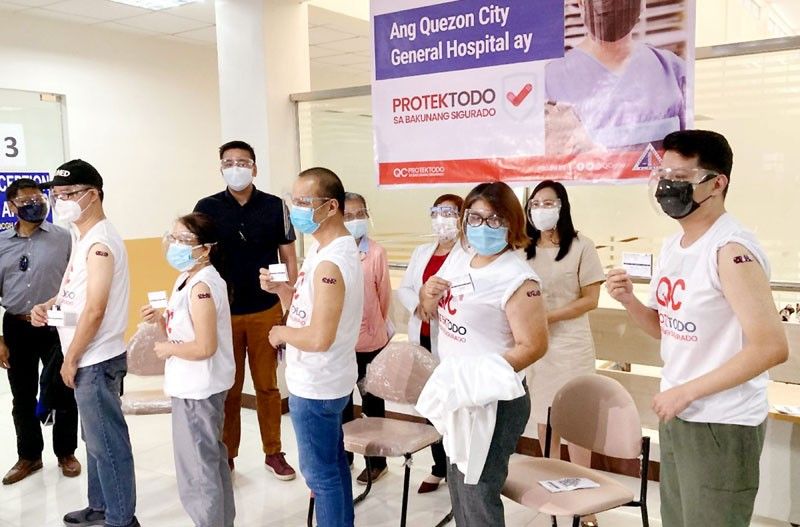 Quezon City health workers get vaccine jabs