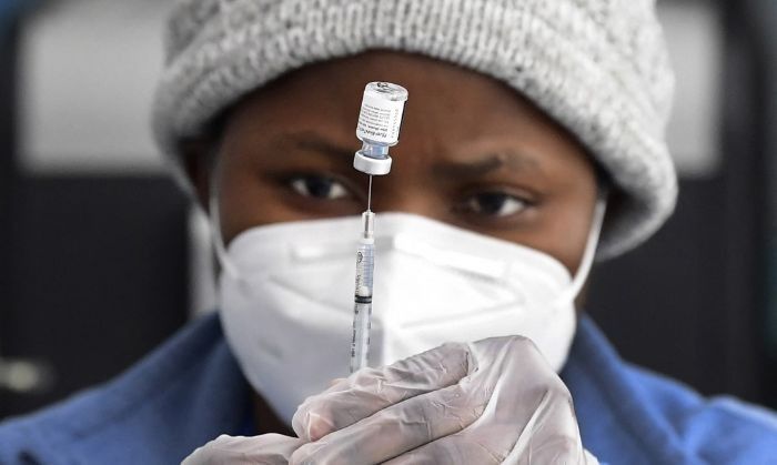 Vaccine hope, but enduring fear one year after pandemic declared