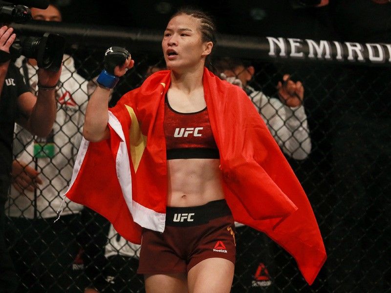 China's UFC champion Zhang defends title before virus jab