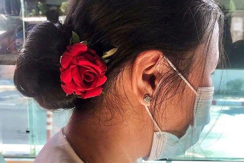 Myanmar protesters wear flowers to mark Suu Kyi's birthday