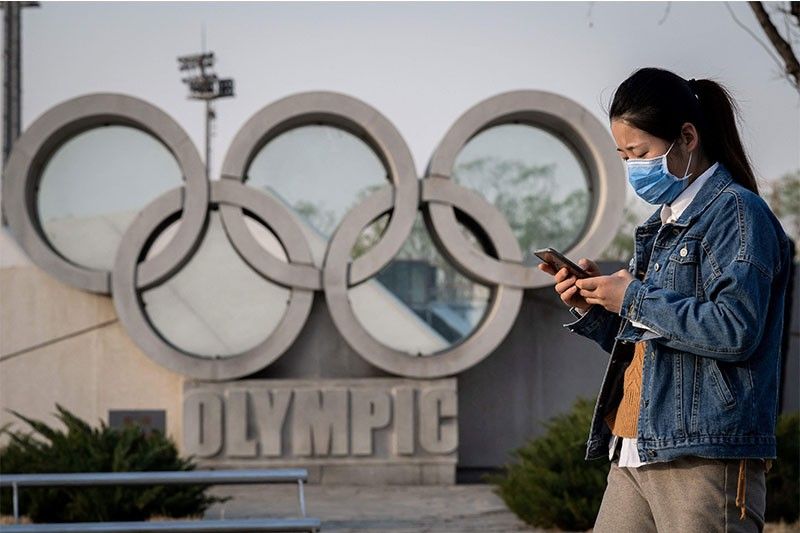 Tokyo hands Olympic baton to Beijing but virus, boycott calls weigh