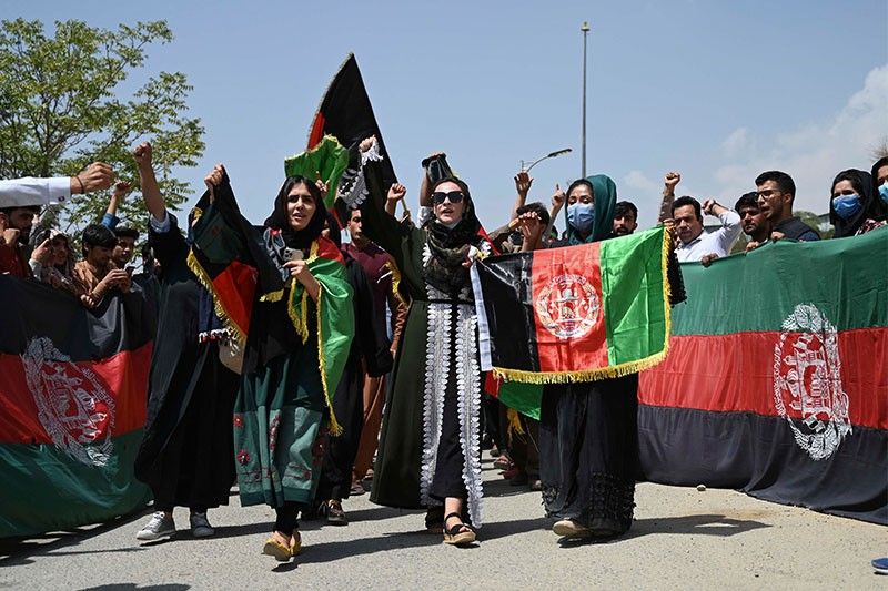Defiant Afghans wave flags amid fears of Taliban crackdown