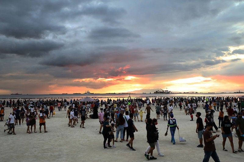 Authorities limit access as thousands flock to Manila's dolomite beach