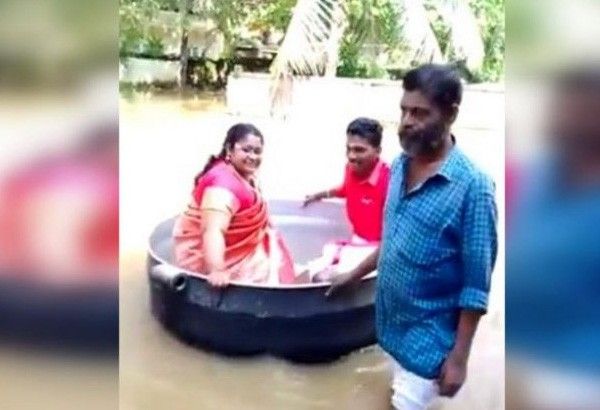 Indian couple sail to wedding in cooking pot, despite floods