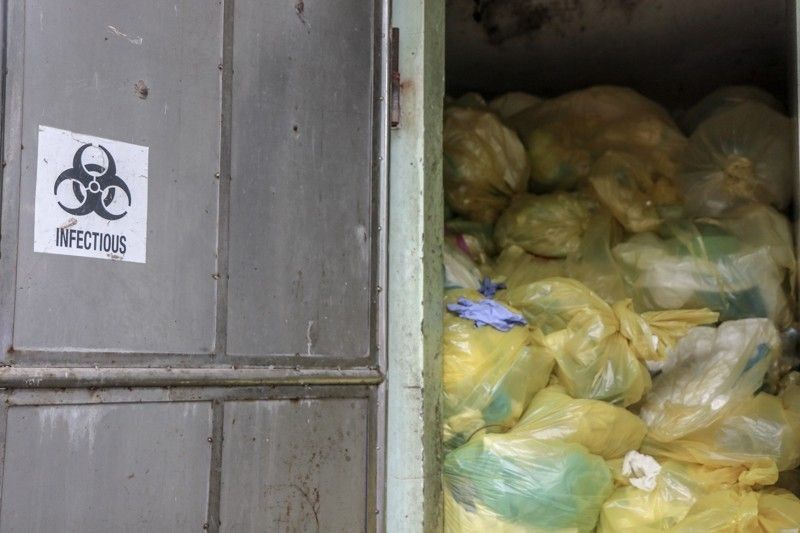 Yellow trash bins, bags set for COVID-19 waste