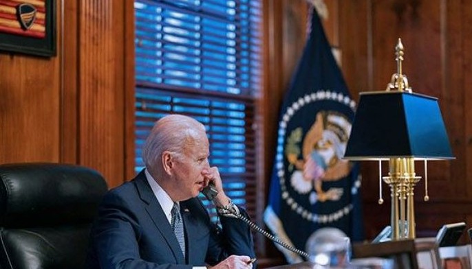 In this image provided by the White House on December 30, 2021 US President Joe Biden speaks on the phone.