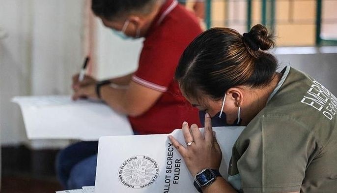 People cast their votes in the presidential election at a polling precinct in Batac, Ilocos Norte on May 9, 2022.