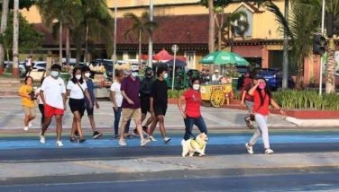Families enjoy an afternoon stroll and other leisurely activities at the baywalk along Roxas Boulevard in Manila on Sunday (May 1, 2022) as the National Capital Region (NCR) remains on Alert Level 1 until May 15.