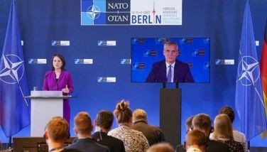 NATO Secretary General Jens Stoltenberg is seen on a video screen as German Foreign Minister Annalena Baerbock addresses a press conference after the informal meeting of NATO Foreign Ministers on the conflict in Ukraine on May 15, 2022 in Berlin.