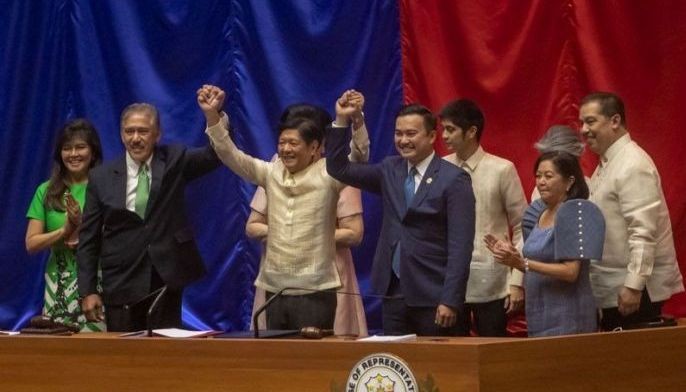 Senate President Vicente Sotto III and House Speaker Lord Allan Velasco raise the hands of President-elect Ferdinand Marcos Jr. at the Batasan Pambansa in Quezon City on May 25, 2022. Marcos was elected by a landslide against closest rival Vice President Leni Robredo.