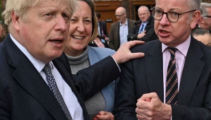 UK PM fires ally and digs in despite calls to quit