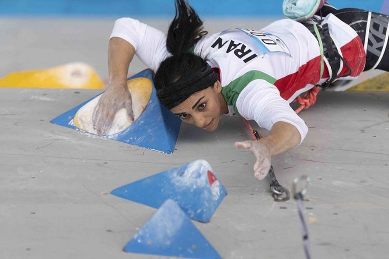Iranian climber greeted as hero after competing without hijab