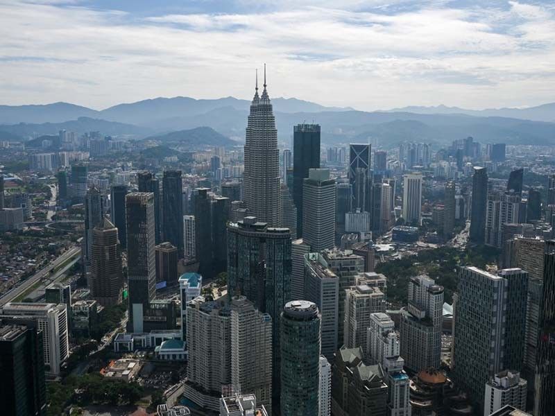 A general view shows the Petronas Twin Towers (C) and other commercial buildings as seen from KL Tower in Kuala Lumpur on September 8, 2022.