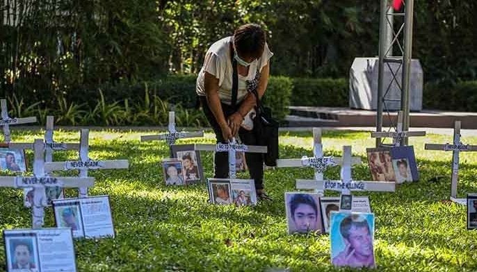 A relative of a victim of an extra-judicial killing attends a memorial mass ahead of All Soul's Day to remember loved ones slain in the government's war on drugs, at the Commission on Human Rights in Manila on October 29, 2021. 