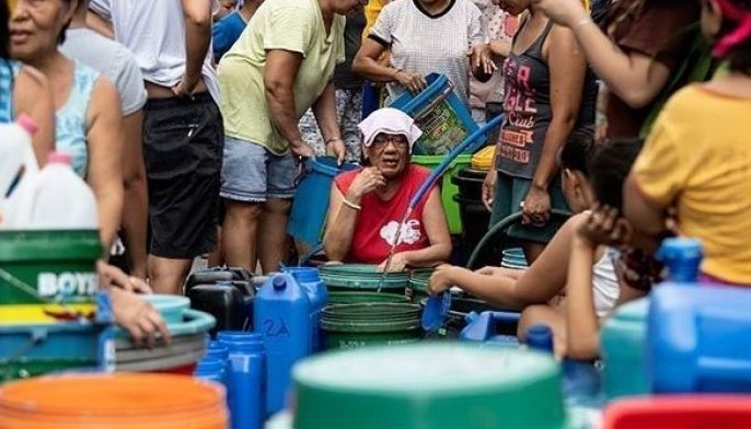 This photo taken on March 14, 2019 shows residents of Barangka in Manila, gathering water. Manila has been hit by its worst water shortage in years, leaving bucket-bearing families to wait hours for a fill up from tanker trucks and some hospitals to turn away less urgent cases