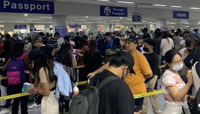 Passengers line up to go through immigration counters at the Ninoy Aquino International Airport (NAIA) Terminal 3 in Pasay City on March 4, 2023.