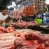 Vendors at the Commonwealth Market in Quezon City sell pork products to customers on March 28, 2023. 