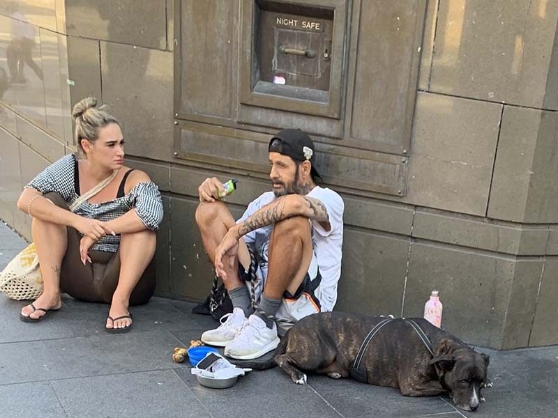 A man uses a disposable vape on a corner in Sydney, Australia in March 2023.