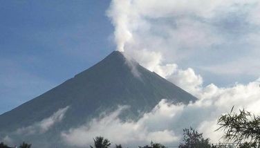 This handout photo made available by Kristin Moral shows the Mount Mayon spewing white smoke as seen from Camalig on June 8, 2023 Hundreds of families living around Mount Mayon in central Albay province are expected to be moved to safer areas after the Philippine Institute of Volcanology and Seismology raised a &quot;hazardous eruption&quot; alarm. 