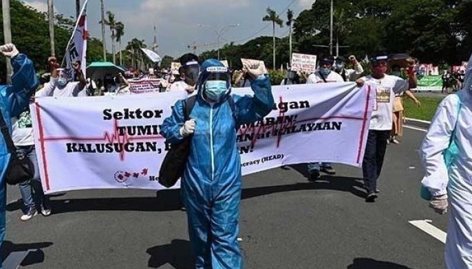 Health workers wearing protective gear march towards the state university grounds in Manila on July 27, 2020, ahead of Philippine President Rodrigo Duterte&acirc;��s State of the Nation Address in Congress.