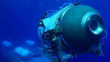 This undated image courtesy of OceanGate Expeditions, shows their Titan submersible launching from a platform. Rescue teams expanded their search underwater on June 20, 2023, as they raced against time to find a Titan deep-diving tourist submersible that went missing near the wreck of the Titanic with five people on board and limited oxygen. All communication was lost with the 21-foot (6.5-meter) Titan craft during a descent June 18 to the Titanic, which sits at a depth of crushing pressure more than two miles (nearly four kilometers) below the surface of the North Atlantic.