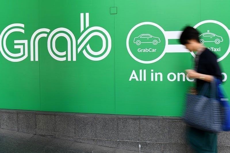 Marcos eyes ease of restrictions for Grab, TNVS operators