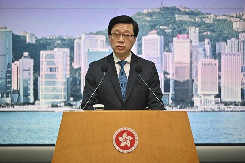 Hong Kong leader says wanted activists should give up or live 'in fear'