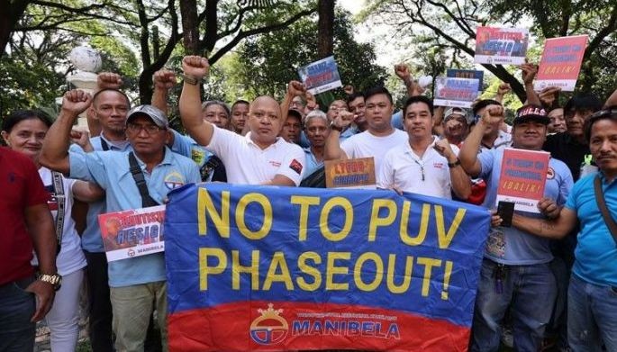 This photo shows Mar Valbuena with members of transport group Manibela in a protest against the Public Utility Vehicle Modernization Program. 