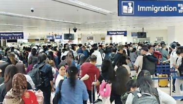 File photo shows passengers waiting in line at the immigration area as the Ninoy Aquino International Airport Terminal 3 services more international flight departures and arrivals. 