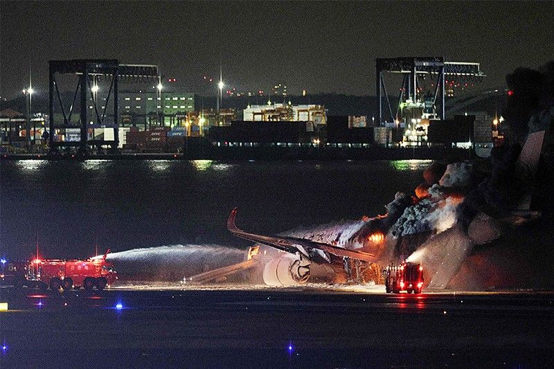Japan Airlines plane on fire on runway at Tokyo's Haneda airport â�� TV images