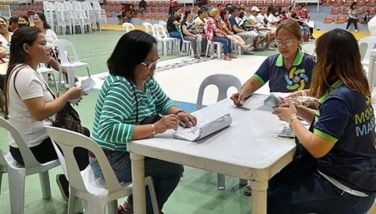 Residents of Mandaue City troop to Mandaue City Sports Complex to receive financial assistance through the city government&acirc;��s Tabang Program.
