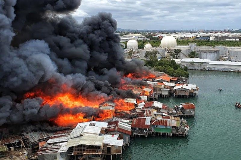 Inferno under the bridge: Fire leaves hundreds homeless