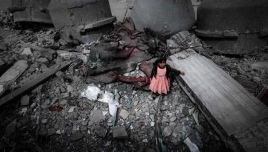 A Palestinian girl wearing a pink dress stands amidst the ruins of the Al-Faruq Mosque that was destroyed during Israeli bombardment, in Rafah on the southern Gaza Strip on March 22, 2024, amid ongoing battles between Israel and the militant group Hamas