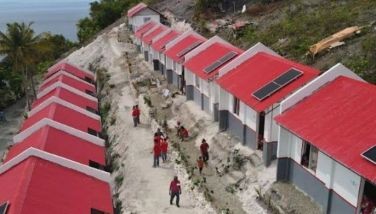 An aerial shot of some of the shelters with solar-powered panels turned over by the Philippine Red Cross and International Federation of Red Cross and Red Crescent Societies to the families that lost their homes to Typhoon Odette in Barangay Poblacion, Alegria, Cebu yesterday. 