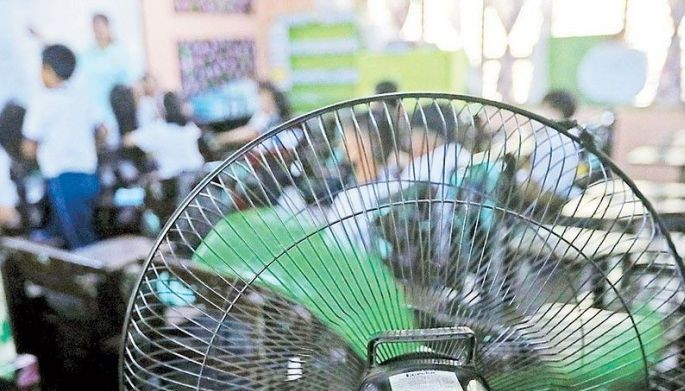 Additional electric fans have been set up inside a classroom of the Rafael Palma Elementary School in Manila yesterday to keep students cool in the hot weather.