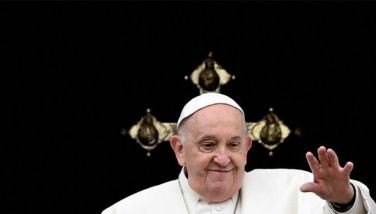 Pope Francis waves from the central loggia of St. Peter's basilica during the Easter 'Urbi et Orbi' message and blessing to the City and the World as part of the Holy Week celebrations, in the Vatican on March 31, 2024. 