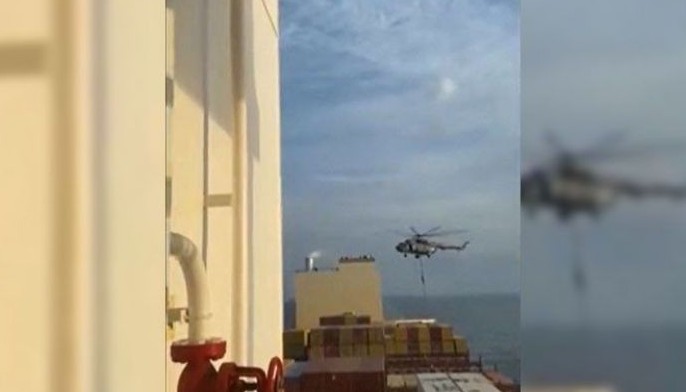 This image grab taken from a UGC video posted on social media on April 13, 2024 shows Iran's Revolutionary Guards rappelling down onto a container ship named, MSC Aries, near the Strait of Hormuz. Iran's Revolutionary Guards on Saturday seized a container ship &quot;related to the Zionist regime (Israel) in the Gulf,&quot; state media reported, as tensions soar in the region.
