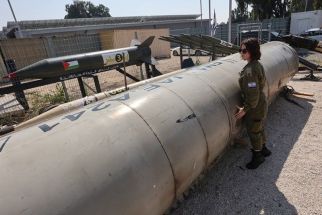A member of the Israeli military stands next to an Iranian ballistic missile which fell in Israel on the weekend, during a media tour at the Julis military base near the southern Israeli city of Kiryat Malachi on April 16, 2024. Iran carried out an unprecedented direct attack on Israel overnight April 13-14, using more than 300 drones, cruise missiles and ballistic missiles, in retaliation for a deadly April 1 air strike on the Iranian consulate in Damascus. Nearly all were intercepted, according to the Israeli military.