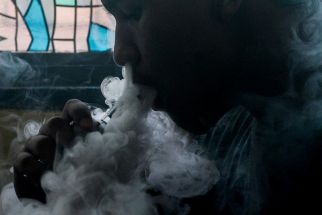 This photo illustration shows a customer smoking at a vape store in Manila on November 20, 2019. Just hours after Philippine President Rodrigo Duterte announced he would ban e-cigarette use, police were ordered on November 20 to begin arresting people caught vaping in public and to confiscate the devices.