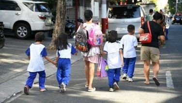 Parents accompany their children from school after their classes in Manila on April 5, 2024. Thousands of schools in the Philippines suspended in-person classes on April 5, the education department said, as parts of the tropical country endured dangerously high temperatures.