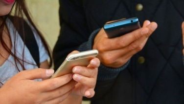 Stock image of people using their mobile phone.