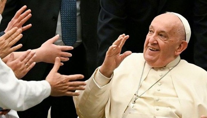 Pope Francis waves during an audience with Hungarian pilgrims in Paul VI hall at the Vatican on April 25, 2024.