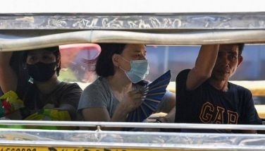 A woman cools off with a folding hand fan inside a passenger jeepney in Manila on April 25, 2024. Extreme heat is scorching parts of South and Southeast Asia, prompting health warnings from authorities as high temperatures are recorded across the region.