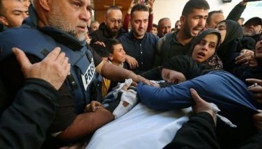 The widow (R) of Hamza Wael Dahdouh, a journalist with the Al Jazeera television network, and his father Al Jazeera's bureau chief in Gaza, Wael Al-Dahdouh (L) mourn over his body during his funeral, after he was killed in a reported Israeli air strike in Rafah in the Gaza Strip on January 7, 2024. UNESCO on May 2 awarded its world press freedom prize to all Palestinian journalists covering the war in Gaza, where Israel has been battling Hamas for more than six months. 