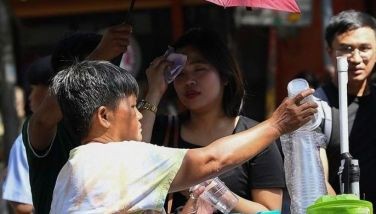 A vendor sells coconut water as a customer (background C) wipes her face during a heatwave in Manila on April 29, 2024. Unusually hot weather in the Philippines was expected to last until mid-May, a forecaster said April 28, after the temperature hit a record high in the capital Manila. 