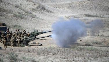 US and Philippine Marines fire M198 155mm Howitzer artillery during a live fire exercise against an imaginary &quot;invasion&quot; force as part of the joint US-Philippines annual military Balikatan drills on a strip of sand dunes in Laoag on Luzon island's northwest coast on May 6, 2024.