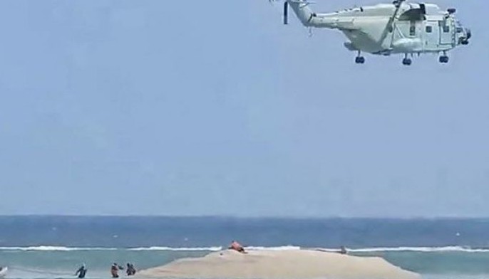 This frame grab from video footage taken and released on March 25, 2024 by the Philippine Bureau of Fisheries and Aquatic Resources (PCG/BFAR) shows a Chinese helicopter hovering as Philippine scientists inspect a cay near the Philippine-held Thitu Island, in the Spratly Islands, in the disputed South China Sea. Deputy foreign ministers from China and the Philippines held a tense phone call on March 25, 2024, Beijing said, after Manila summoned a Chinese envoy over &quot;aggressive actions&quot; by the China Coast Guard in the contested South China Sea.