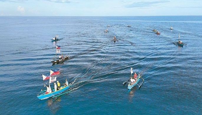Fisherfolk from Zambales conduct a fluvial protest off the coastal municipality of Candelaria yesterday to condemn the continuous harassment by the Chinese coast guard and to show solidarity with President Marcos in asserting sovereign rights in the West Philippine Sea.