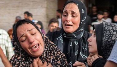 Graphic content: Women react after the death of a child relative who was injured during bombardment on a displaced persons camp, outside the Aqsa Martyrs Hospital in Deir el-Balah in the central Gaza Strip on May 11, 2024 amid the ongoing conflict in the Palestinian territory between Israel and Hamas.